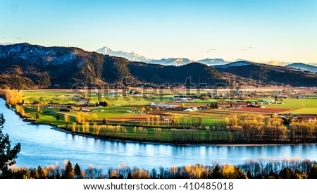 The fertile farmland of the Fraser Valley in British Columbia south of the Fraser River with Mount Baker in the distant background behind Sumas Mountain from Mission Hill, north of the Fraser River Royalty-Free Stock Photo #410485018