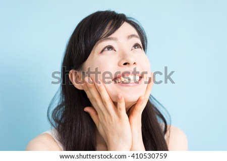 Happy young woman against blue background