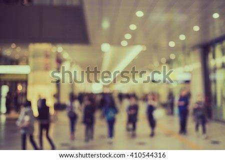 Blurred tourists in shopping mall with bokeh - retro color