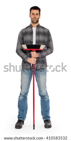 Full isolated studio picture from a young worker with a broom
