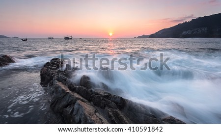 sunset over the sea with beautiful wave