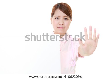 Young female nurse making stop sign