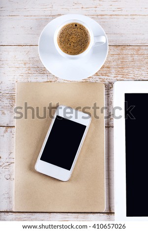tablet computer, notebook, mobile phone and coffee cup