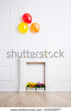 Decorative white fireplace on white wall background.