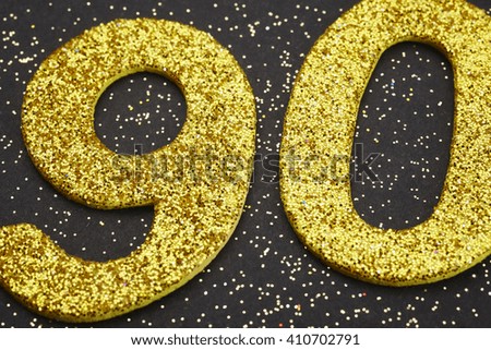 Number ninety golden color over a black background. Anniversary. Horizontal