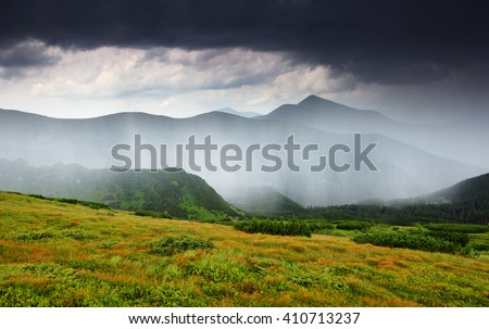 Wonderful view of the rain clouds over the wooded mountains. Dramatic and picturesque scene. Location place National park Chornogora, Carpathian, Ukraine, Europe. Artistic picture. Beauty world.