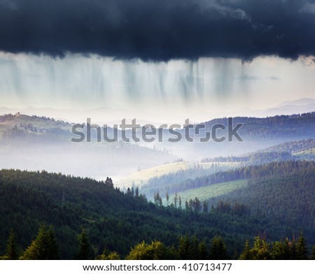 Wonderful view of the rain clouds over the wooded mountains. Dramatic and picturesque scene. Location place National park Chornogora, Carpathian, Ukraine, Europe. Artistic picture. Beauty world.