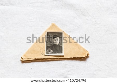The letter, folded triangle and a photo of the young Russian Soviet soldier during the Second World War.