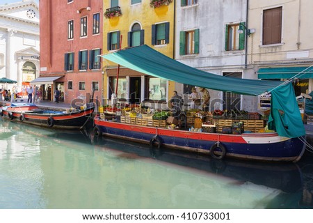 Floating fruit market in Venice, Italy. Scenery photography of floating river market of Venice. Venice market near colorful Italian buildings. Famous Italian city, Venice. Traditional river market