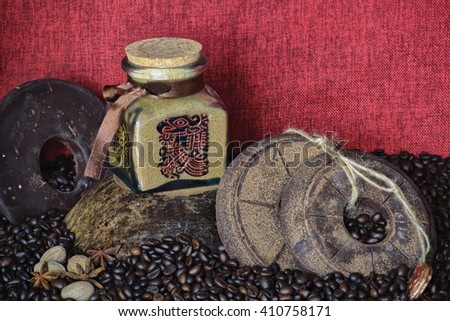custom painted glass can with traditional aztec pictures coffee bean background with handmade round chocolate 