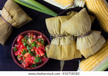Latin American food. Traditional homemade humitas of corn. Top view Royalty-Free Stock Photo #410758582