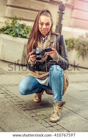 Female Tourist Photographer. Pretty young female tourist photographer taking pictures in the city