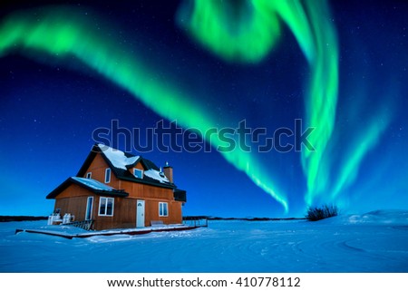 A Colorful Aurora Borealis Sky Over Great Slave Lake  
 Royalty-Free Stock Photo #410778112