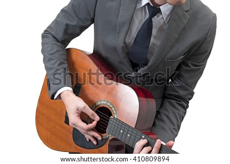 Businessman playing acoustic guitar isolated on white background.