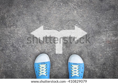 Teenagers wearing blue shoes standing at the crossroad and has to make a decision which way to go