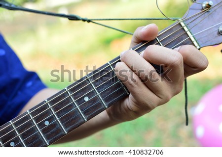 man playing guitar on C chord