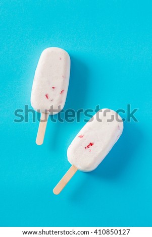 Delicious popsicles on isolated blue background