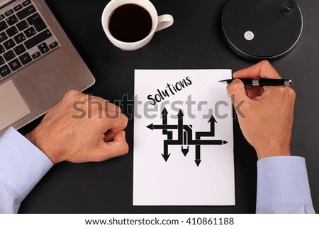 Business solutions, choice concept. Businessman writing to notebook on a in the office