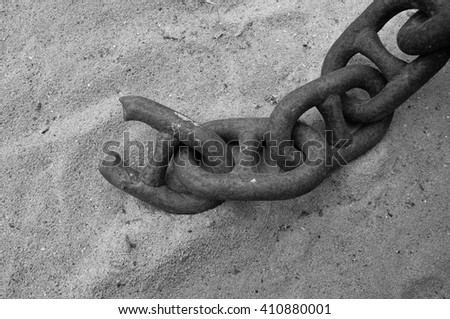 A broken chain in black and white. The weakest links decides what the outcome will be.