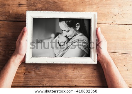 Mothers day composition. Picture frame. Wooden background. Studi