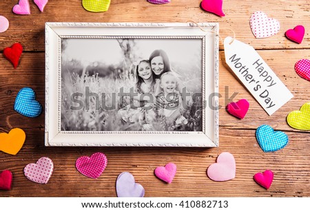 Mothers day composition, picture frame. Studio shot, wooden, bac