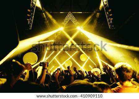night party festival crowd of people silhouettes hands up Royalty-Free Stock Photo #410909110
