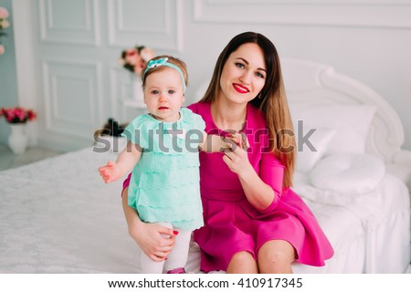 Mother and baby closeup portrait, happy faces, european family picture, adorable small girl, mom and kid having fun indoor, parents joy, child, healthy toddler and mommy, happiness concept