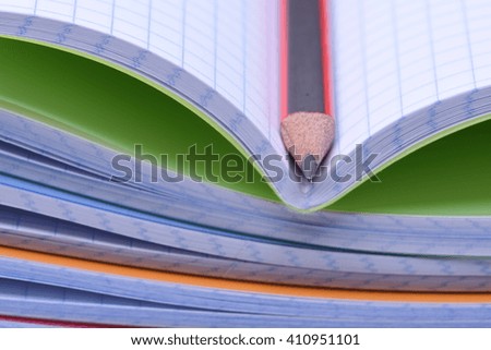 Exercise books and pencil