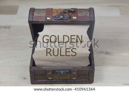 golden rules is written on the brown torn paper in the treasure box