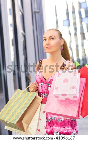 outdoor picture of attractive woman with shopping bags