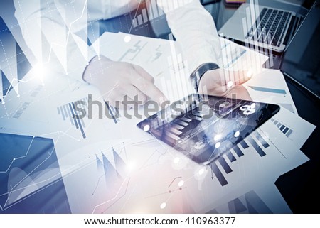 Bank manager working process.Closeup photo trader work market report modern tablet.Using electronic device.Graphics icon,worldwide stock exchanges interface.Business project startup.Film,bokeh effect