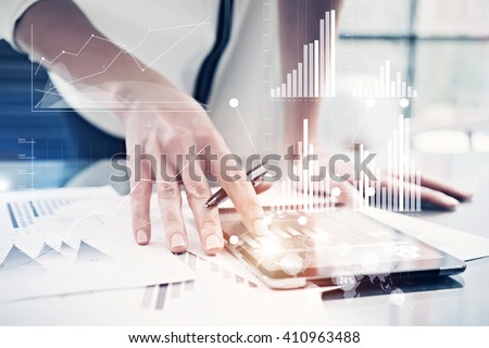 Picture female hand touching modern tablet.Investment manager working new private banking project office.Using electronic device.Graphic icons,worldwide stock exchanges interface on screen. Horizontal Royalty-Free Stock Photo #410963488