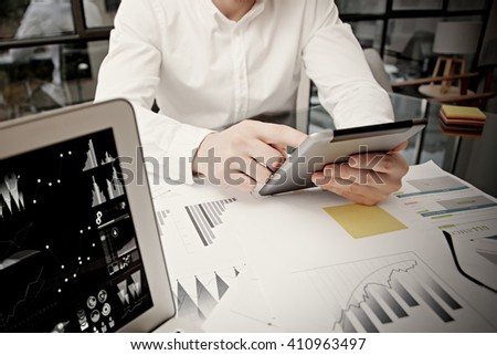 Photo businessman touching modern tablet screen.Trader manager working new private banking project office.Using electronic devices.Graphics icons,worldwide stock exchanges notebook. Bokeh,film effect