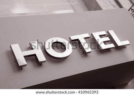 Hotel Sign on Grey Background in Black and White Sepia Tone