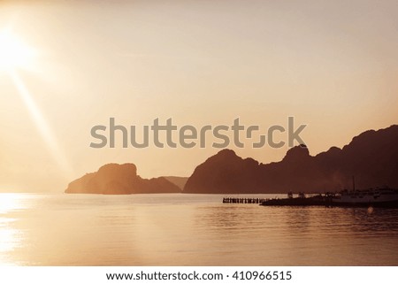 Serene picture of yellow summer sunrise at sea in Thailand.