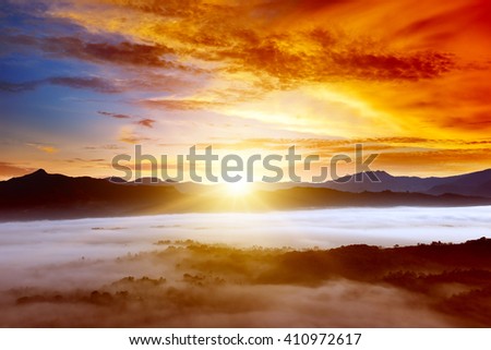 Sunrise in the mountains in the fog