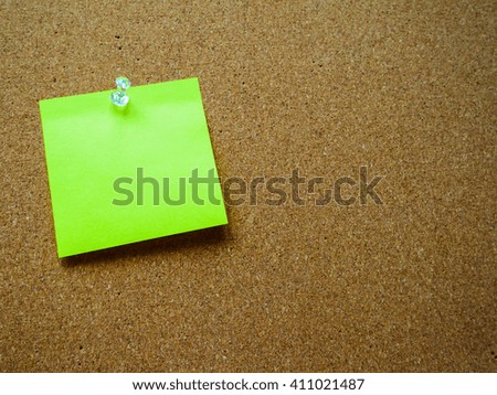 Green paper note on wooden board with copy space