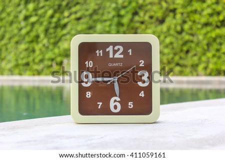 Clock on concrete floor at 05.45 A.M. or P.M.