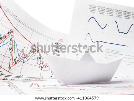 Business concept of paper boat and documents with text and graphs