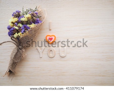 I love You words and dry flowers on wood background