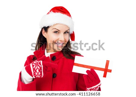 Beautiful brunette pointing a christmas gift on white background