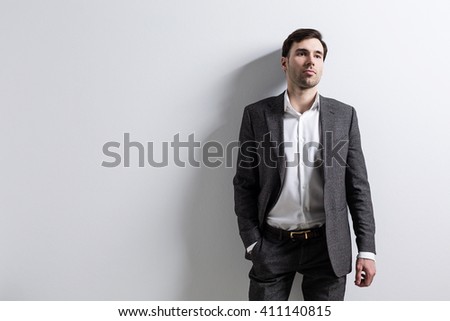 Businessman with empty wall in the background. Mock up