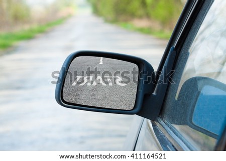Car mirror. The reflection in the mirror of the word start. Business concept