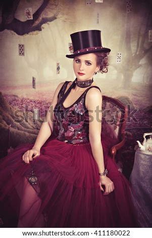 Evil Queen in bowler sitting on the armchair