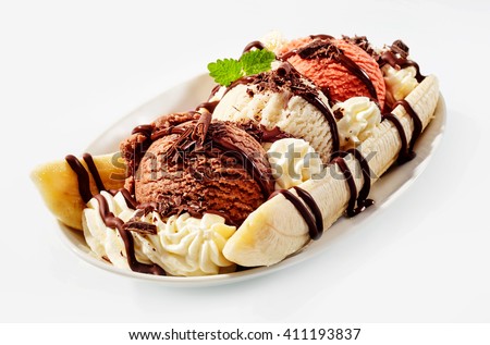 Banana split sundae ice cream in a bowl with strawberry and raspberry vanilla icecream scoops Royalty-Free Stock Photo #411193837