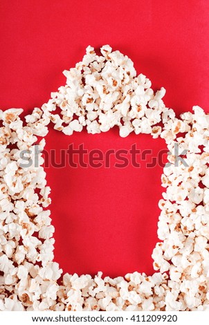 full box of popcorn on a red background