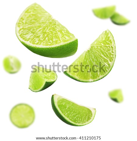 Falling limes isolated on white Royalty-Free Stock Photo #411210175