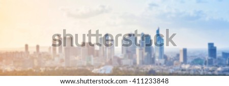 Blurred panoramic background. Modern cityscape with skyscrapers under colorful sky