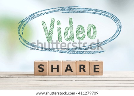 Share video sign on a wooden table with a sketch