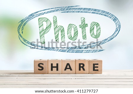 Share photo sign on a wooden desk